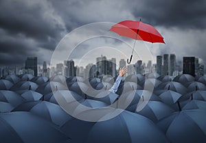 Businessman with red umbrella among others, unique different concept