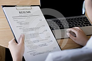 Business man review his resume application on desk