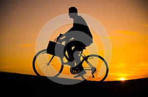 Business man riding bicycle on the hill