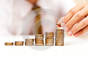 Business man with rising coins photo