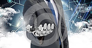 Business man with robot hand with clouds in background