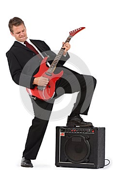 Business man rocking out on red guitar