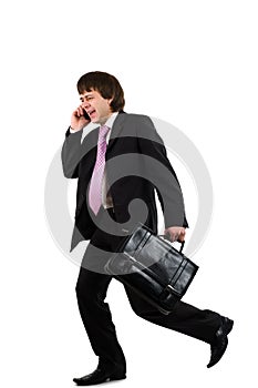 Business man running and speaking by phone
