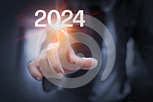 Business man\'s hands Touching the year 2024.