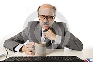 Business man 60s working stressed and frustrated at office computer laptop desk looking tired and overwhelmed