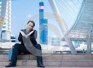 Business man say no with crossed arms hands refusing and cancel concept with city background