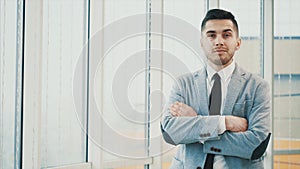 Business man is serious, looking at the camera, isolated on white blurred background. Copy space. 4K.