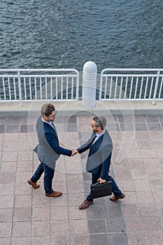 Business man shaking hands. Two businessmen handshake outdoor. Handshake business people. Handshake of two business man