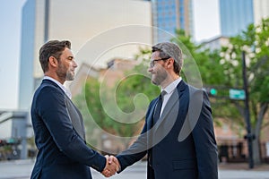 Business man shaking hands. Two businessmen handshake outdoor. Handshake business people. Motivation and inspiration for