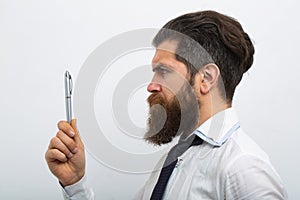 Business man in shirt and tie holding note pad and pen. Close up profile of surious man. Idea. Portrait of attractive