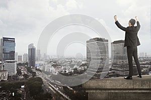 Business man shout on the building rooftop