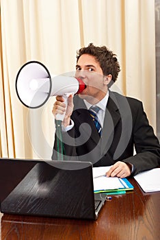 Business man shouting in megaphone