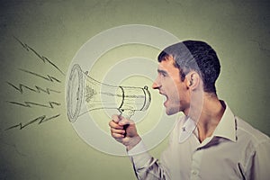 Business man shouting into a megaphone isolated on gray background