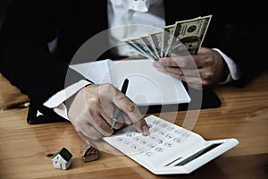 Business man show money bank note make financial plan invite people to sell or buy house and car