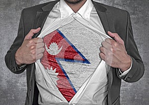 Business man show t-shirt flag of Nepal rips open his shirt