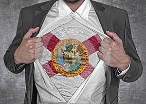 Business man show t-shirt flag of USA state Florida rips open his shirt