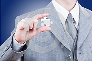 Business man showing blank jigsaw puzzle piece