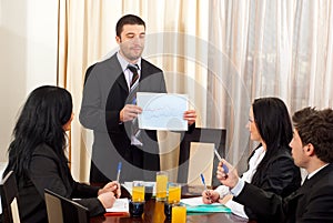 Business man showing graphic at meeting