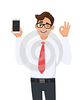 Business man showing, holding new brand, latest smartphone, cell, mobile phone and gesturing, making okay, OK sign while winking.