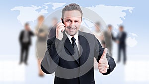 Business man showing like while talking on the phone