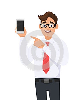 Business man showing a new brand, latest smartphone screen and pointing finger. Young man holding cell, mobile phone in hand.