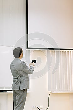 Business man showing presentation on a multimedia projector background. Technology concept. Copy space.