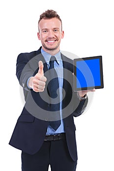 Business man shows tablet and thumb up