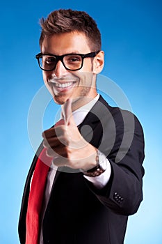 Business man shows thumbs up ok gesture