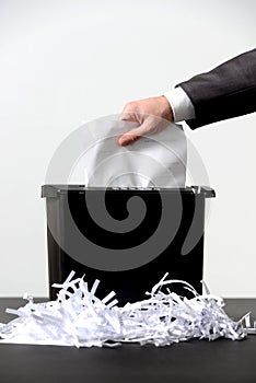 Business man shredding a document