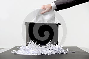 Business man shredding a document