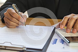 Business man signing a contract. Owns the business sign personally,director of the company, solicitor. Real estate agent holding