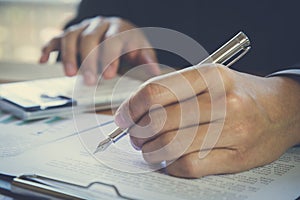 Business man signing a contract. Owns the business sign personally, director of the company, solicitor. Real estate agent holding