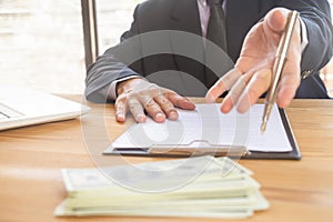 Business man signing a contract. Owns the business sign personally, director of the company, solicitor. Real estate agent holding