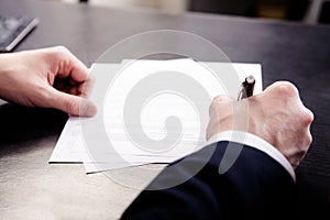 Business man signing the contract - shallow focus on signature