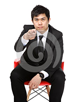 Business man sit and point to you
