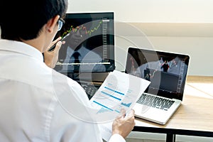 Business man sit at ther table looking at computer