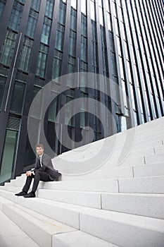 Business man siting on stairs