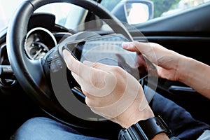 business man Sitting in the Car and Using digital tablet.