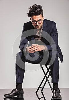 Business man sitting on chair and looking down