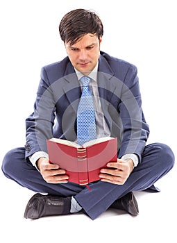 Business man sitting cross-legged and reading