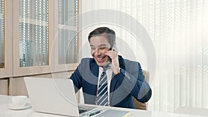 Business man sitting using laptop study online work at his desk success celebration at office