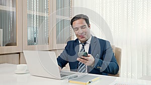 Business man sitting using laptop study online work at his desk success celebration at office