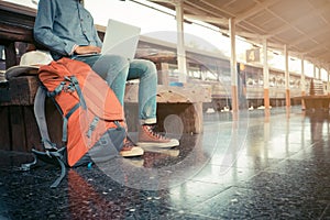 Business man sitting with using laptop. travel bag at the train