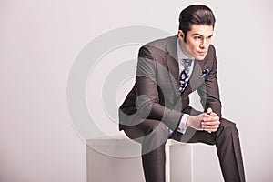 Business man sitting on a white modern chair