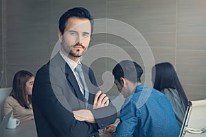 Business man smart and handsome standing with team mates working in meeting room at office