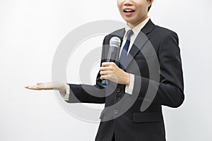 Business man smiling, speaking holding microphone at conference