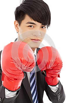 Business man sneer and ready to fight with boxing gloves