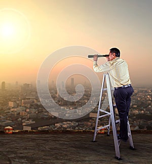 Business man spying lens on high building roof against skyscrap