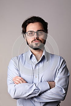 Business man standing in corporate portrait isolated on white wall. Vertical.