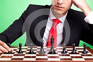 Business man standing in front of chess line-up